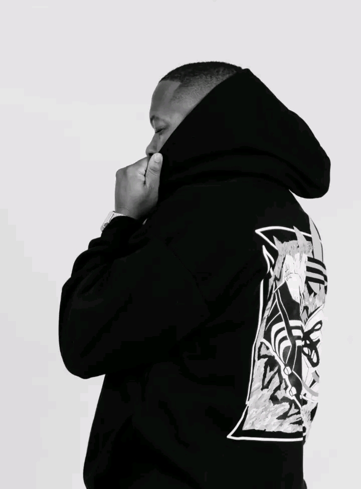 Sphe D in profile wearing a black graphic hoodie
